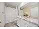 Bright bathroom featuring double sinks with white cabinets, a large mirror, and shower at 5800 Elegant Orchid Way, Sarasota, FL 34232