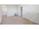 Neutral bedroom features two closets, a plush rug, and doors for easy access at 5800 Elegant Orchid Way, Sarasota, FL 34232