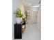 Inviting entryway features gray tile flooring, a black console table, and neutral walls offering a modern aesthetic at 5800 Elegant Orchid Way, Sarasota, FL 34232