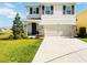 Charming two-story home with a two-car garage, stone accents, and a well-manicured lawn at 5800 Elegant Orchid Way, Sarasota, FL 34232