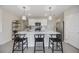Kitchen island with pendant lighting and seating offers a modern design and open layout at 5800 Elegant Orchid Way, Sarasota, FL 34232