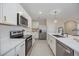 Modern kitchen featuring white cabinets, stainless steel appliances, and quartz countertops at 5800 Elegant Orchid Way, Sarasota, FL 34232