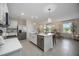 Bright kitchen boasts stainless steel appliances, a center island, and easy dining room access at 5800 Elegant Orchid Way, Sarasota, FL 34232