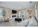 Bright living room features a fireplace, TV, and sliding glass doors to outdoor space at 5800 Elegant Orchid Way, Sarasota, FL 34232
