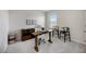 Bright office features a wooden desk with chairs, plush carpet, and natural light at 5800 Elegant Orchid Way, Sarasota, FL 34232
