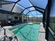 Sparkling screened-in pool with ample seating and brick pool deck perfect for enjoying sunny days at 5800 Elegant Orchid Way, Sarasota, FL 34232