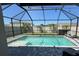 Inviting screened-in pool with a well-maintained pool deck and beautiful backyard at 5800 Elegant Orchid Way, Sarasota, FL 34232