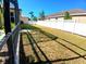 Large, fenced backyard featuring a manicured lawn, pool and potential for outdoor activities at 6631 63Rd E Ter, Bradenton, FL 34203