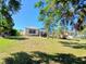 Expansive backyard features lush grass and mature trees, offering a serene outdoor space at 6631 63Rd E Ter, Bradenton, FL 34203