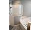 Well-lit bathroom showcases a tiled shower with glass enclosure and a corner soaking tub at 6631 63Rd E Ter, Bradenton, FL 34203
