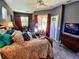 Cozy bedroom features wood floors, a ceiling fan, and sliding glass doors to the lanai at 6631 63Rd E Ter, Bradenton, FL 34203