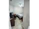 Small bedroom featuring neutral colors, a ceiling fan, wood-look floors and a streamlined desk area at 6631 63Rd E Ter, Bradenton, FL 34203