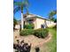 Beige single-story home with red shutters and well-manicured landscaping at 6631 63Rd E Ter, Bradenton, FL 34203