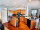 Open kitchen with stainless steel appliances, a breakfast bar, and wood floors, ideal for cooking and entertaining at 6631 63Rd E Ter, Bradenton, FL 34203