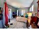 Spacious main bedroom features a ceiling fan, wood flooring, multiple windows, closet, and television at 6631 63Rd E Ter, Bradenton, FL 34203