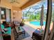 Covered patio area that is furnished and overlooks the pool, perfect for outdoor living and dining at 6631 63Rd E Ter, Bradenton, FL 34203