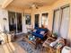 Covered patio with comfortable seating, a ceiling fan, and sliding glass doors leading to the interior at 6631 63Rd E Ter, Bradenton, FL 34203