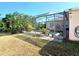 Beautiful backyard with screen enclosed pool and tropical plants at 6631 63Rd E Ter, Bradenton, FL 34203