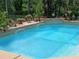 Close-up of the sparkling blue swimming pool with its relaxing water features and surrounding tile work at 6631 63Rd E Ter, Bradenton, FL 34203