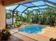 Relaxing screened pool with lush landscaping offers a private backyard oasis for leisure and recreation at 6631 63Rd E Ter, Bradenton, FL 34203