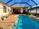 Backyard pool with covered screen, complemented by a patio area perfect for outdoor relaxation and entertaining at 6631 63Rd E Ter, Bradenton, FL 34203
