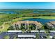 Aerial view of condo building offering golf course frontage, covered parking, and lush landscaping at 7005 River Hammock Dr # 402, Bradenton, FL 34212