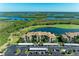 Beautiful aerial view of the community featuring a body of water, golf course, and covered parking at 7005 River Hammock Dr # 402, Bradenton, FL 34212