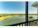Screened lanai showing golf course, water view and blue sky in this lovely residential community at 7005 River Hammock Dr # 402, Bradenton, FL 34212