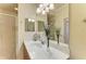 Modern bathroom with a sleek vanity, large mirror, stylish lighting, and a glass-enclosed shower at 7005 River Hammock Dr # 402, Bradenton, FL 34212