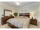 Well-lit bedroom with a large bed, dresser, mirror, and nightstands, providing a relaxing atmosphere at 7005 River Hammock Dr # 402, Bradenton, FL 34212