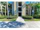 Well-maintained building entrance with lush landscaping, visible unit numbers, and easy accessibility at 7005 River Hammock Dr # 402, Bradenton, FL 34212