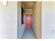 Exterior view of a condo entrance door with natural lighting and a glimpse of the interior at 7005 River Hammock Dr # 402, Bradenton, FL 34212