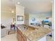 Open-concept kitchen with granite countertops, a sink, and a view of the living area at 7005 River Hammock Dr # 402, Bradenton, FL 34212