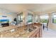 Spacious kitchen featuring granite countertops, stainless steel sink, and a view of the living area at 7005 River Hammock Dr # 402, Bradenton, FL 34212