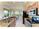 Bright kitchen with granite countertops, stainless steel appliances, and a dining area with views at 7005 River Hammock Dr # 402, Bradenton, FL 34212