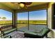Relaxing screened lanai with comfortable seating and scenic water and green views at 7005 River Hammock Dr # 402, Bradenton, FL 34212