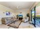 Comfortable living room with a sofa, armchair, and a sliding door leading to the balcony at 7005 River Hammock Dr # 402, Bradenton, FL 34212