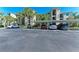 Condo parking lot featuring covered parking spots at 7005 River Hammock Dr # 402, Bradenton, FL 34212