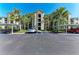 Well-maintained parking lot with covered parking spaces, surrounding lush landscaping and palm trees at 7005 River Hammock Dr # 402, Bradenton, FL 34212