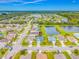 An aerial view of a neighborhood with a pond, showcasing the layout and surroundings of the community at 7107 58Th E Ter, Palmetto, FL 34221