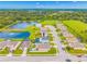 This aerial view captures a residential community with a scenic pond and fountain for a tranquil atmosphere at 7107 58Th E Ter, Palmetto, FL 34221