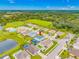 An aerial view highlights a residential neighborhood with homes, manicured lawns, and community ponds at 7107 58Th E Ter, Palmetto, FL 34221