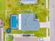An aerial view of a home with a screened in pool and lush landscaping in a residential neighborhood at 7107 58Th E Ter, Palmetto, FL 34221