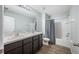 A bathroom with double vanity and lots of storage space is accented by a shower with tile surround at 7107 58Th E Ter, Palmetto, FL 34221