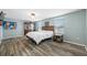 Light-filled bedroom boasts wood-look floors, a cozy bed, and ample natural light from the bright windows at 7107 58Th E Ter, Palmetto, FL 34221