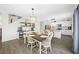 Dining area with wood table and white chairs near open kitchen and staircase at 7107 58Th E Ter, Palmetto, FL 34221