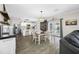 Bright dining area with modern light fixture, seating for four, and access to the outdoor pool area at 7107 58Th E Ter, Palmetto, FL 34221