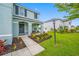 Charming home entrance with a cozy porch, decorative landscaping, and a welcoming gray door at 7107 58Th E Ter, Palmetto, FL 34221