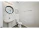 Clean half bathroom featuring a pedestal sink, toilet, and decorative mirror at 7107 58Th E Ter, Palmetto, FL 34221
