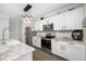 Modern kitchen with stainless steel appliances, white cabinetry, and stylish backsplash at 7107 58Th E Ter, Palmetto, FL 34221